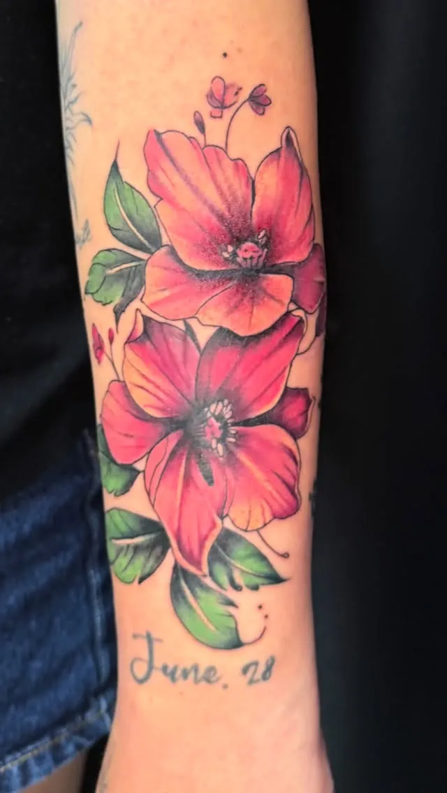 Colour realism hibiscus flowers tattoo on the forearm