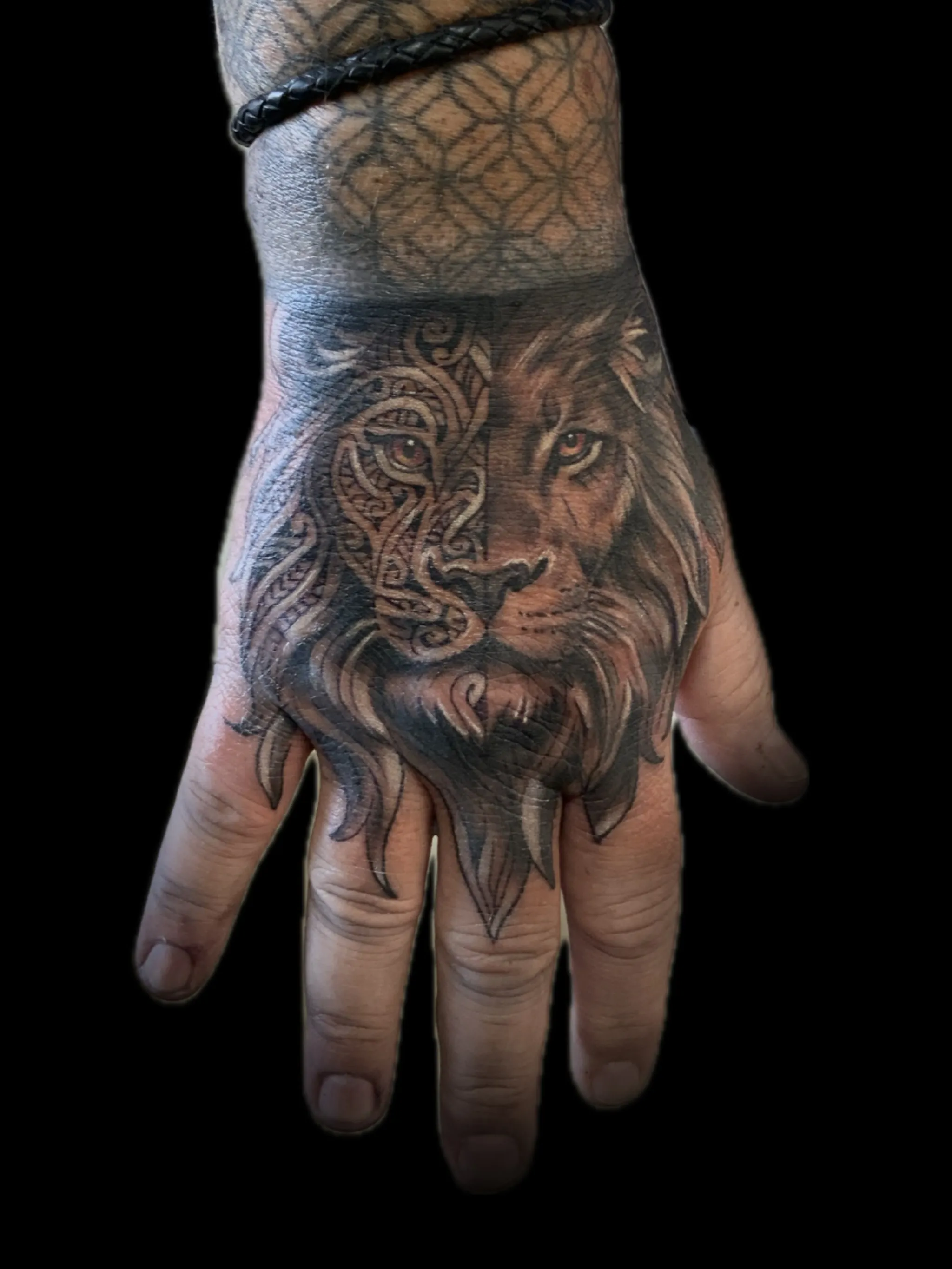 Black and grey realism lion tattoo on the hand