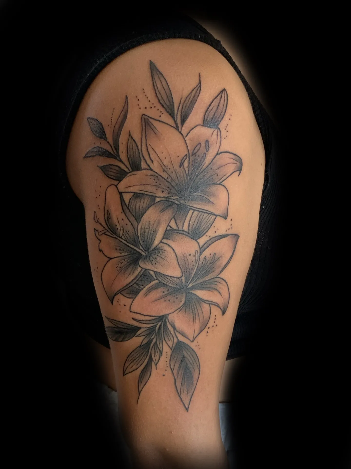 Fine line lily flower shoulder tattoo